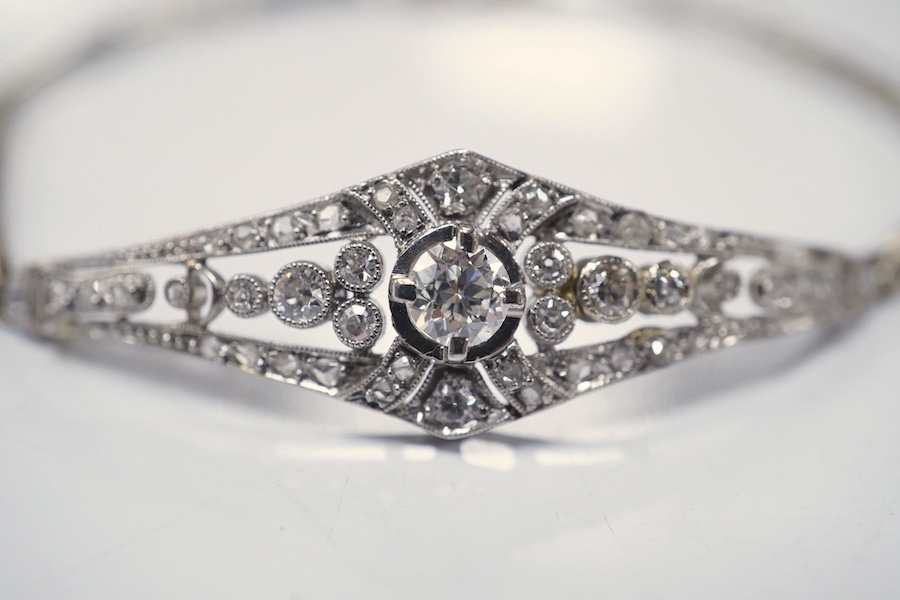 An early 20th century pierced gold, platinum and diamond set bracelet, the central motif set with round, eight and rose cut stones, 18cm, gross weight 8.9 grams. Condition - fair to good